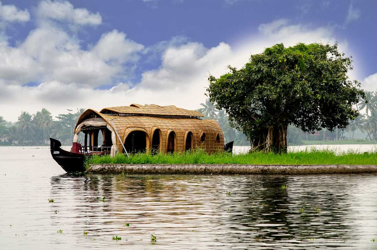 Peaceful boat stay in Kerala backwaters with natural beauty and traditional wooden houseboat