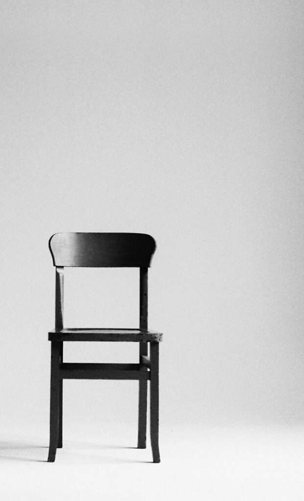 Elegant wooden chair with cushion in room